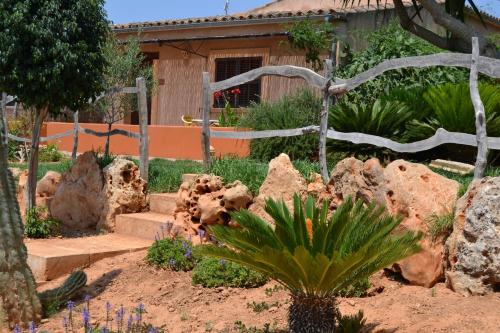 a garden with rocks and plants in front of a house at Agroturismo Finca Son Sala in Campos