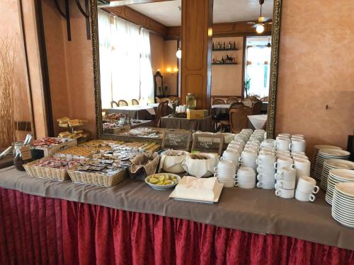 a table with a buffet of food on it at Hotel AMALFI in Lido di Jesolo