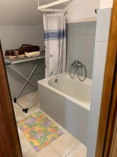 a bathroom with a tub and a shower curtain at Marta in Matulji