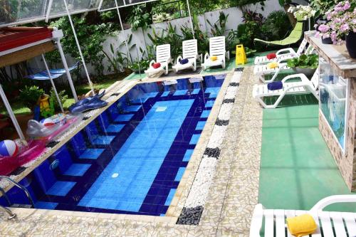 
a swimming pool with a blue and white pool table and chairs at Colombo Villa at Cambridge Place in Colombo
