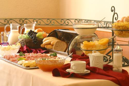 a table with a buffet of food on it at Hotel Roudna in Plzeň