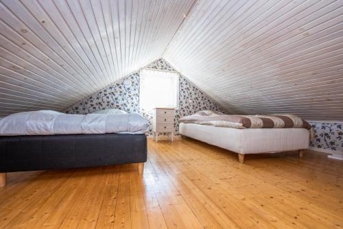 una camera mansardata con due letti e una finestra di Luleå Village Cabin a Luleå