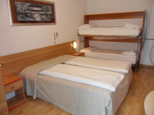 Postel nebo postele na pokoji v ubytování Hotel Rialto