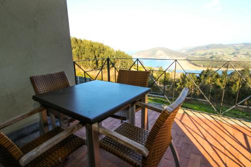 a table and chairs on a balcony with a view at Apartamentos Monterodiles in Liñero
