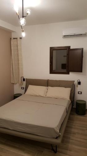 a bedroom with a large bed with a mirror at da Matilda in Agrigento