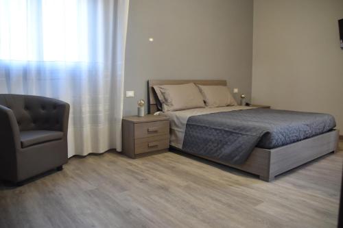 a bedroom with a bed and a chair at La Culla del Mugello in Scarperia