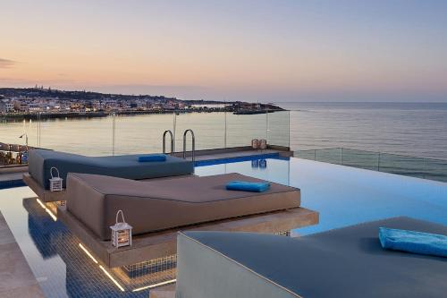 a swimming pool on the roof of a house at Seafront Apartments by Myseasight in Hersonissos