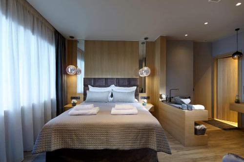 a bedroom with a large bed with two towels on it at Seafront Apartments by Myseasight in Hersonissos