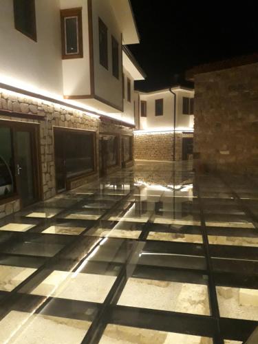 an empty courtyard of a building at night at Side Tuana Garden Home in Side