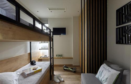 a bedroom with a bunk bed and a couch at Seafront Apartments by Myseasight in Hersonissos