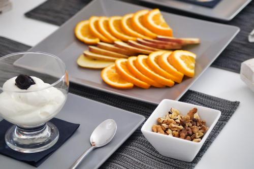 a plate of sliced oranges and a bowl of yogurt at Santo Castello in Akrotiri
