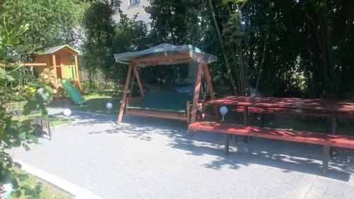 a playground with a bench and a swing at BASTÓWKA 2 Apartamenty in Ustroń
