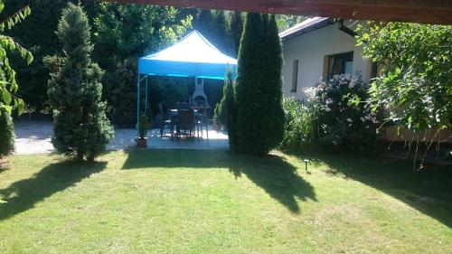 a blue and white tent in a yard at BASTÓWKA 2 Apartamenty in Ustroń