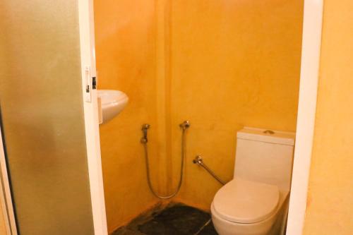 a bathroom with a toilet and a sink at Namaste Jungle - A Boutique Homestay in Assagao