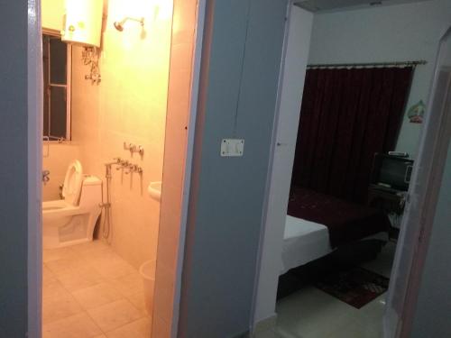 a bathroom with a shower and a toilet and a sink at Comfort Point Bed & Breakfast in New Delhi