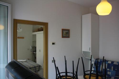 a room with chairs and a mirror in a room at Residence Le Vele in Cattolica