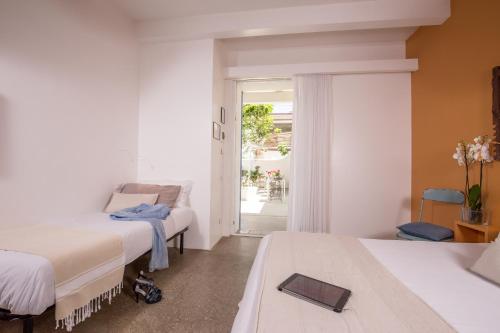a hotel room with two beds and a window at Hotel Intorno Al Fico in Fiumicino