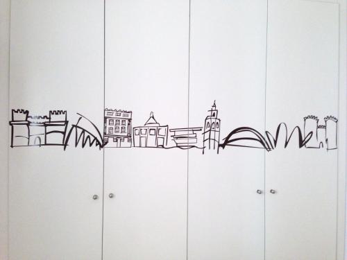 a city skyline drawing on top of cabinets at Edificio Palomar - PalomarGroup in Valencia