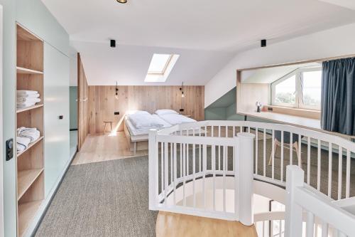 a bedroom with a crib and a bunk bed at Designhotel Whitman in Ascheberg