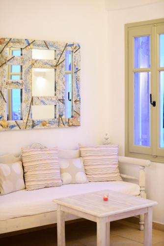 a living room with a couch and a table at Paolas Sunset in Agios Stefanos