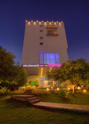 a white building with lights on it at night at Hotel Parc Estique in Pune