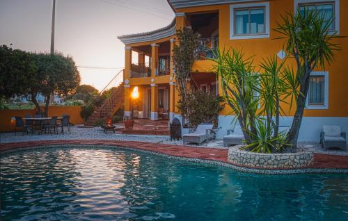 a house and a swimming pool in front of a house at Moonshine Guest House with private studios and private cottage in Lagos