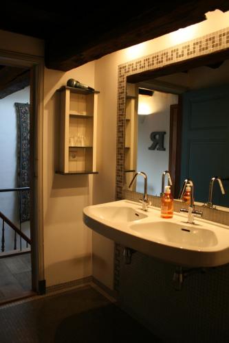 a bathroom with a sink and a mirror at B&B Au Lion D'or in Maastricht