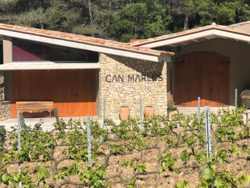 a building with a sign on the side of it at CAL PUIG, ENOTURISMO RURAL entre Viñas y Bosques in Juncosa