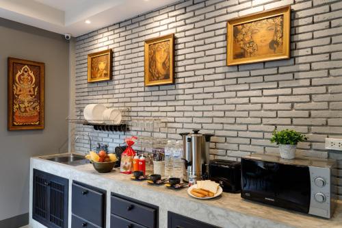 a kitchen with a counter top with a microwave at Hostel One Art and Gallery in Chiang Mai