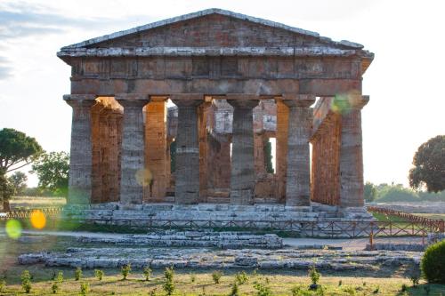 an ancient building with columns in a field at Fuori le Mura in Paestum