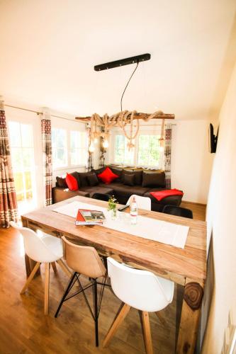 a kitchen and living room with a table and chairs at Black Forest Apartements by Hotel Grüner Baum Feldberg in Feldberg