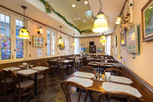 a restaurant with tables and chairs and windows at Suzuka Royal Hotel in Suzuka