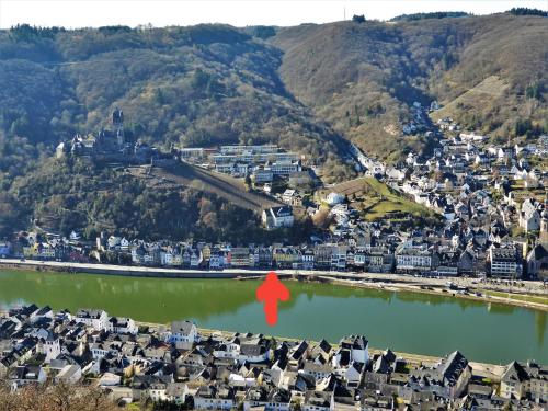 an aerial view of a town with a red marker in the water at Pension Winnemuller in Cochem