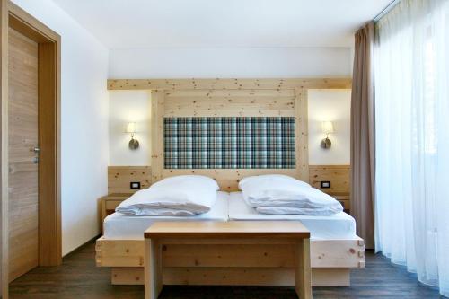 Ένα ή περισσότερα κρεβάτια σε δωμάτιο στο Garnì La Tranquillitè