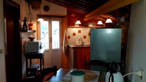 a kitchen with a green refrigerator and a window at Borgo Vecchio in Carbognano