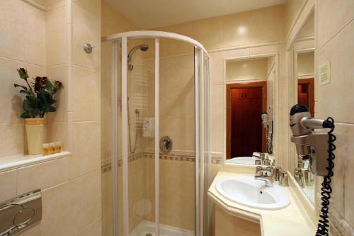 a bathroom with a shower and a sink at Hotel Roudna in Plzeň