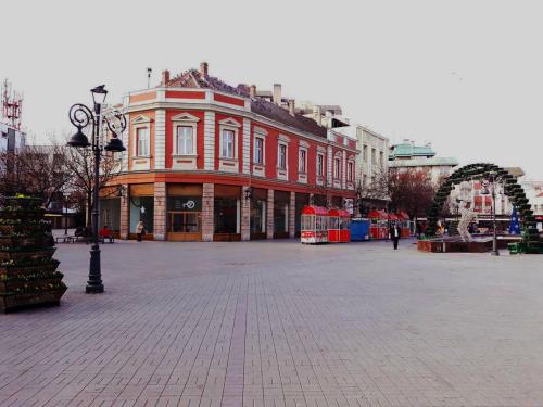 a large brick building in a city with an arch at Prenociste Nikolas Grand in Smederevo