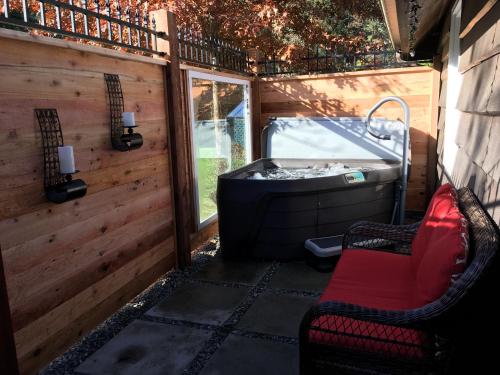 a screened in porch with a tub and a chair at Amante Luxury Bed & Breakfast in Victoria