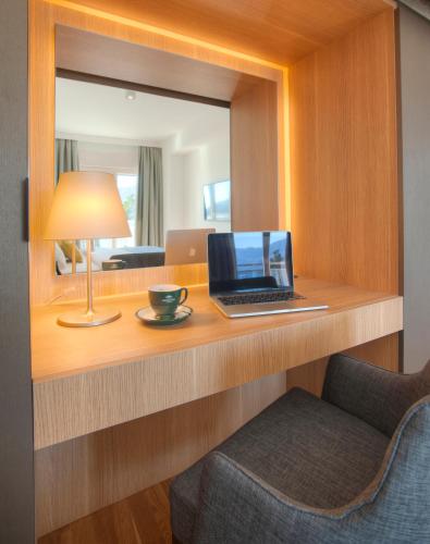 a laptop sitting on a desk in a hotel room at Fontana Hotel & Gastronomy in Budva