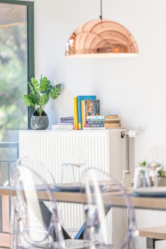 a dining room table with chairs and a potted plant at Gregory’s Loft in Ayia anna