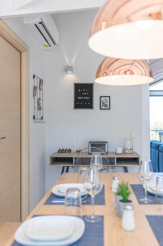 a dining room with a table with plates and glasses at Gregory’s Loft in Ayia anna
