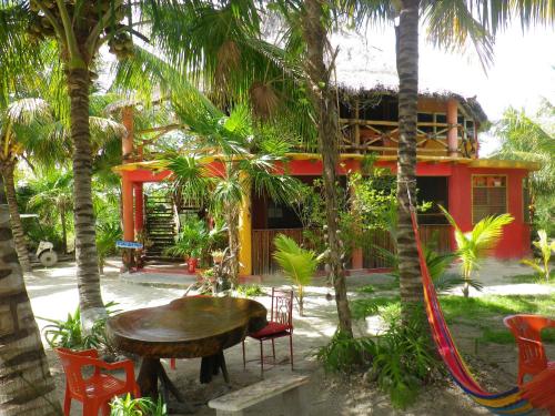 a table and chairs in front of a house at Casa Cereza in Holbox Island