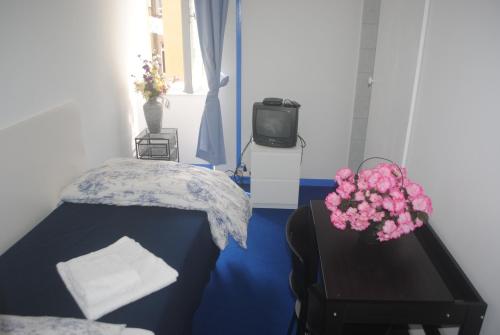 Ένα ή περισσότερα κρεβάτια σε δωμάτιο στο Olympia Hotel