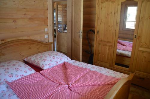 a bedroom with a bed with a pink bow on it at Schwalli's Ferienhaus Am Wipperberg in Korbach