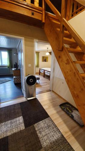 a living room with a staircase and a living room at Gasthof Schlossberg in Signau