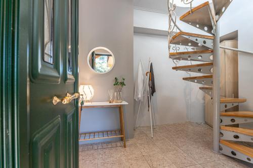 a green door in a room with a staircase at Gregory’s Loft in Ayia anna