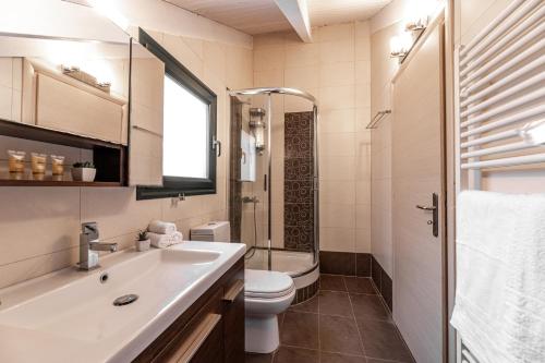 a bathroom with a sink and a toilet at Gregory’s Loft in Ayia anna