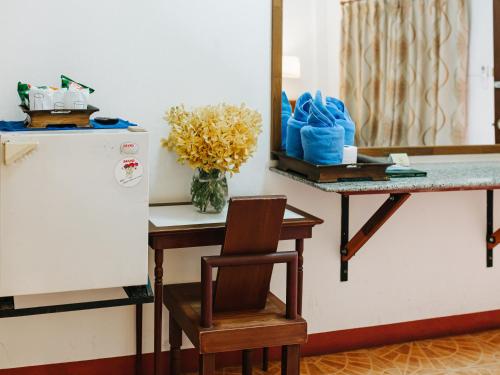 a kitchen with a table and a chair and a counter at Rendezvous Oldtown Chiangmai in Chiang Mai