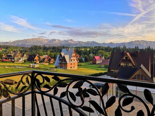 a view from a balcony of a village with mountains at Domki Skalnica in Poronin