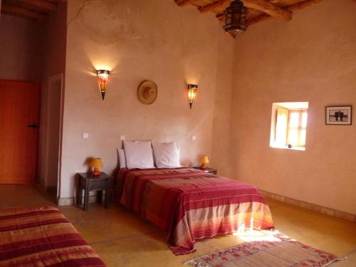Ein Bett oder Betten in einem Zimmer der Unterkunft Kasbah Timdaf